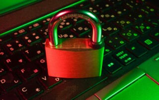 Padlock on laptop keyboard with red green lighting